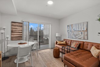 Bright living and dining area with access to a private balcony. - The Ruby