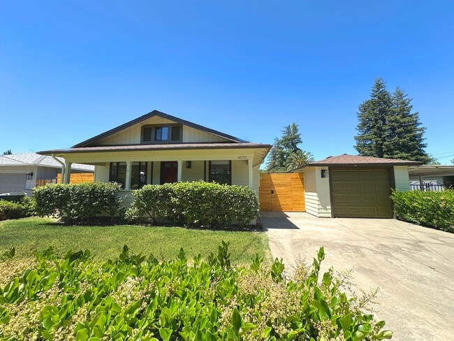 Curb appeal on display with a modern façade, garage, and stylish front door. - 4570 58th St