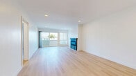 Located in the heart of Venice, CA, this thoughtfully designed 1-bedroom, 1-bathroom unit offers a clean, modern aesthetic throughout. Light-toned hardwood flooring flows seamlessly across all living areas, creating a bright and cohesive feel.

The open-concept kitchen and living room serve as the heart of the home. The kitchen features sleek white shaker cabinetry extending to the ceiling, a marble-style tile backsplash, quartz countertops, a peninsula for additional prep space, and stainless steel appliances including a French door refrigerator and built-in microwave. Recessed lighting illuminates the space throughout.

The living area is anchored by a contemporary tiled fireplace and large sliding glass doors that open to a private balcony, offering elevated views of the surrounding Venice neighborhood, palm trees, and open sky.

The generously sized primary bedroom includes a ceiling fan, a window with natural light, and a mirrored sliding closet that also houses a stacked in-unit washer and dryer—a rare and practical convenience.

The bathroom is a standout feature, finished with floor-to-ceiling marble-veined tile in the walk-in shower with a frameless glass enclosure and rain showerhead, complemented by a white vanity with quartz countertop and wood flooring.

A hallway connects all rooms, adding to the efficient and functional layout of this stylish Venice residence.