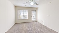 Located at 305 E Peachtree Dr in Nixa, MO, this single-floor, one-bedroom, one-bathroom residence offers a practical and well-organized layout across a comfortably sized floor plan. The kitchen is a standout feature, showcasing light maple cabinetry, warm laminate countertops, tile flooring, and a peninsula island with a double stainless steel sink — ideal for both meal prep and casual dining. White appliances, including a range, microwave, and refrigerator, complete the kitchen's functional setup. The kitchen flows naturally into the dining room and adjoining living room, which features plush carpeting, a ceiling fan with light fixture, and windows that invite natural light. A separate door in the living area provides access to the outdoors. The bedroom is a well-proportioned retreat with carpet flooring, a ceiling fan, and a window offering natural light. Three closets throughout the unit provide generous storage. The bathroom features tile flooring, a wood-toned vanity with an oversized mirror, and a tub/shower combination with grab bars. Additional utility is offered through a dedicated laundry room and utility room. Textured ceilings and neutral tones throughout give the space a clean, move-in-ready feel.