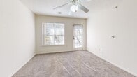 Located at 305 E Peachtree Dr in Nixa, MO, this single-floor, one-bedroom, one-bathroom residence offers a practical and well-organized layout across a comfortably sized floor plan. The kitchen is a standout feature, showcasing light maple cabinetry, warm laminate countertops, tile flooring, and a peninsula island with a double stainless steel sink — ideal for both meal prep and casual dining. White appliances, including a range, microwave, and refrigerator, complete the kitchen's functional setup. The kitchen flows naturally into the dining room and adjoining living room, which features plush carpeting, a ceiling fan with light fixture, and windows that invite natural light. A separate door in the living area provides access to the outdoors. The bedroom is a well-proportioned retreat with carpet flooring, a ceiling fan, and a window offering natural light. Three closets throughout the unit provide generous storage. The bathroom features tile flooring, a wood-toned vanity with an oversized mirror, and a tub/shower combination with grab bars. Additional utility is offered through a dedicated laundry room and utility room. Textured ceilings and neutral tones throughout give the space a clean, move-in-ready feel.