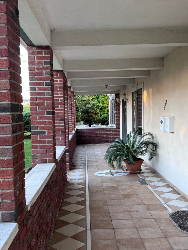 covered porch entry with left door street level acess - 239 Kingston Ave