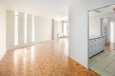 Located at 20 N Shore Blvd W in Burlington, Ontario, this well-appointed 2-bedroom, 1-bathroom unit offers a clean, modern aesthetic throughout its thoughtfully designed floor plan. The open kitchen and living area form the heart of the unit, where the kitchen showcases white cabinetry, granite-look countertops, a marble-style tile backsplash, stainless steel appliances, and ceramic tile flooring. A breakfast bar peninsula connects the kitchen to the living space, which features warm parquet hardwood flooring and a striking wall of tall vertical windows that flood the room with natural light. The spacious primary bedroom includes sliding glass doors opening onto a private balcony with treetop views, along with a closet and direct access to the shared bathroom. The second bedroom also features parquet flooring, a dedicated closet, and convenient access to the bathroom. The bathroom is finished with modern tile flooring, a granite-topped vanity, and a glass-enclosed walk-in shower. A hallway and additional closet provide practical storage. Throughout the unit, neutral tones and consistent flooring create a cohesive and inviting atmosphere, making it a comfortable and functional living space.