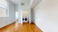 Located at 2100 Pickens St in Columbia, SC, this 2-bedroom, 3-bathroom residence offers a well-appointed single-floor layout with a thoughtful mix of modern finishes and character-rich details. The kitchen is a standout feature, showcasing rich dark cabinetry with brushed nickel hardware, light granite countertops, a classic white subway tile backsplash, and stainless steel appliances including a double oven range and built-in microwave — all set above warm hardwood floors. The open living area benefits from tall windows that invite generous natural light and offer views of the surrounding brick streetscape. The primary bedroom features soaring ceilings, original hardwood flooring with natural patina, and multiple closets for ample storage. The second bedroom offers polished concrete floors, large grid-paned windows, and its own en-suite bathroom. A walk-in closet with painted brick walls and wire shelving adds a distinctive industrial touch. All three bathrooms are finished with dark wood vanities, granite countertops, tub-shower combinations, and tile flooring, with select bathrooms including accessibility grab bars. Throughout the residence, a consistent palette of white walls and warm wood tones creates a clean, inviting atmosphere.