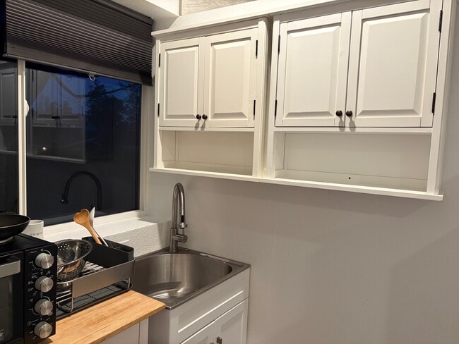 Two cabinets, kitchen sink, window - 136 Farallon Dr