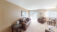 This single-floor residence in Georgetown South offers a well-organized layout designed for comfortable everyday living. The living room serves as the centerpiece of the home, featuring plush wall-to-wall carpeting, warm neutral-toned walls, and a large sliding glass door fitted with vertical blinds that invites an abundance of natural light while providing access to the outdoors. The open feel of this room allows for generous furniture arrangements and flows naturally into a dedicated dining area, complete with its own ceiling light fixture.

The galley-style kitchen is efficiently designed with ample warm-toned wood cabinetry lining both sides, offering considerable storage space. It includes a stainless steel sink, a full-size refrigerator, a dishwasher, and a stovetop, all set atop durable tile flooring.

The bedrooms are carpeted and generously sized, each featuring built-in closets with hanging rods for organized storage. Natural light filters in through windows fitted with blinds. One bedroom features a bold teal accent wall, adding a vibrant focal point to the space, while another includes an eye-catching orange accent wall.

The bathroom is outfitted with a full tub and shower combination, accented by classic white tile surround. Throughout the home, wood-trimmed doorways and neutral walls create a cohesive, understated aesthetic.