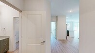 Located at 211 Hammond Center Dr in Raleigh, NC, this 2-bedroom, 2-bathroom residence offers a thoughtfully designed single-story layout finished with consistent light wood flooring throughout. The open living area is bright and airy, featuring large windows with horizontal blinds and a sliding glass door that welcome generous natural light and outdoor views of surrounding greenery. A ceiling fan adds both comfort and style to the living space.

The kitchen is well-appointed with granite countertops, two-tone cabinetry in sage green and white, a subway tile backsplash, stainless steel appliances including a dishwasher and electric range, and a window above the sink that provides additional natural light.

The primary bedroom is generously sized with a ceiling fan and direct access to a dedicated closet. Both bedrooms are bright and open, sharing the same warm wood-look flooring found throughout the home. Each bathroom is finished with granite-topped sage green vanities, large mirrors, tile-surround soaking tubs with curved shower rods, and recessed lighting. Both closets feature wire shelving systems that maximize storage capacity.

The overall aesthetic is clean, modern, and neutral, creating a versatile and move-in ready living environment.