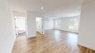 Located at 1185 Myra Ave in the heart of Los Angeles, CA 90029, this thoughtfully designed one-bedroom, one-bathroom unit offers a clean, modern aesthetic throughout its efficiently arranged single-floor layout. Warm light wood flooring flows seamlessly through every room, complementing the bright white walls and creating a fresh, contemporary atmosphere.

The open living area is bathed in natural light from multiple windows, with recessed lighting overhead and a wall-mounted mini-split system ensuring year-round comfort. The galley-style kitchen is well-equipped, featuring white shaker cabinetry with matte black hardware, white quartz countertops, a stainless steel sink with a black faucet, and full-size stainless steel appliances including a refrigerator, gas range, and dishwasher. White subway tile backsplash adds a polished finishing touch.

The bedroom offers a comfortable and tranquil retreat with a window overlooking greenery, a wall-mounted mini-split unit, and a sliding-door closet. The bathroom is distinctly styled with hexagonal slate-gray floor tile, white subway-tiled walls, a soaking tub with a shower, matte black fixtures, and a white vanity with ample cabinet storage. The unit also includes a dedicated closet space with stacked laundry access.