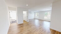Located at 1185 Myra Ave in the heart of Los Angeles, CA 90029, this thoughtfully designed one-bedroom, one-bathroom unit offers a clean, modern aesthetic throughout its efficiently arranged single-floor layout. Warm light wood flooring flows seamlessly through every room, complementing the bright white walls and creating a fresh, contemporary atmosphere.

The open living area is bathed in natural light from multiple windows, with recessed lighting overhead and a wall-mounted mini-split system ensuring year-round comfort. The galley-style kitchen is well-equipped, featuring white shaker cabinetry with matte black hardware, white quartz countertops, a stainless steel sink with a black faucet, and full-size stainless steel appliances including a refrigerator, gas range, and dishwasher. White subway tile backsplash adds a polished finishing touch.

The bedroom offers a comfortable and tranquil retreat with a window overlooking greenery, a wall-mounted mini-split unit, and a sliding-door closet. The bathroom is distinctly styled with hexagonal slate-gray floor tile, white subway-tiled walls, a soaking tub with a shower, matte black fixtures, and a white vanity with ample cabinet storage. The unit also includes a dedicated closet space with stacked laundry access.