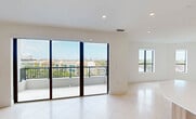 This contemporary apartment in Coral Gables offers 1400 square feet of meticulously designed living space. The open floor plan showcases a seamless flow between rooms, accentuated by light-toned flooring and crisp white walls. The kitchen is a standout feature, boasting sleek cabinetry in a mix of white and natural wood tones, anchored by a distinctive hexagonal island.

Both bedrooms are generously sized, with the primary suite spanning an impressive 280 square feet. Large windows in the bedrooms provide abundant natural light and scenic views. The apartment boasts three full bathrooms, each appointed with modern fixtures and finishes, including floating vanities and spacious showers.

Storage is ample throughout, with custom-built closets featuring adjustable shelving and hanging space. The living areas are illuminated by recessed lighting, enhancing the apartment's modern aesthetic. High ceilings contribute to an overall sense of spaciousness.

Located at 701 Valencia in Coral Gables, this single-story residence combines sophisticated design with functional living, perfect for those seeking a contemporary urban lifestyle in a prime Florida location.