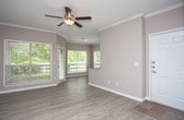This single-story residence in Franklin, Tennessee presents a well-organized layout with a cohesive, neutral design palette throughout. The main living and dining areas feature light hardwood-style flooring, crown molding, and ceiling fans, while multiple windows fitted with blinds flood the spaces with natural light and provide views of surrounding greenery. A back door in the dining area offers convenient outdoor access.

The kitchen is outfitted with white cabinetry, granite countertops, stainless steel appliances including a dishwasher, range, microwave, and refrigerator, along with a peninsula that separates it from the adjacent dining space. The layout supports easy flow between cooking and entertaining areas.

The bedrooms feature plush carpet flooring, neutral walls, and windows that bring in natural light. The primary suite includes access to a spacious walk-in closet equipped with wire shelving and organizational racks for ample storage.

The primary bathroom showcases dual vanities with granite countertops, white cabinetry, light hardwood-style flooring, and a soaking tub with tiled surround. The overall design maintains a clean, functional aesthetic consistent throughout the home.