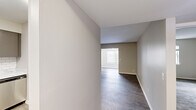 Located at 314 McBrien Rd in Chattanooga, TN, this one-bedroom, one-bathroom unit offers a well-organized single-floor layout with distinct spaces for living, dining, and everyday function. The entrance flows into a hallway finished with dark hardwood-style flooring that continues through the living and dining areas, creating a cohesive and clean aesthetic throughout the main living spaces. Neutral warm-toned walls provide a versatile backdrop across the unit. The kitchen is outfitted with stainless steel appliances including a full-size refrigerator and electric range, gray cabinetry, a classic white subway tile backsplash, and light-toned flooring, giving it a modern and functional character. The bedroom is a generously sized room featuring plush carpeting, a sliding-door closet with a hanging rod, and a window that brings in natural light. The bathroom includes a soaking tub with shower, a marble-top vanity with under-cabinet storage, a large mirror, and modern light fixtures. A dedicated dining area and separate living room complete the layout, offering clear spatial definition throughout this compact yet efficiently designed Chattanooga residence.