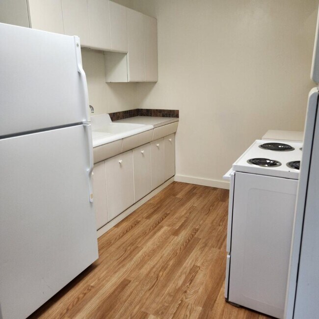 Kitchen with a tile backsplash - 248 E Birch St