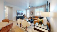 Located at 32000 N 29th Ave in Phoenix, AZ, this single-story home offers three bedrooms and three bathrooms thoughtfully arranged across a well-utilized floor plan. Light wood-style flooring runs throughout, creating a cohesive and airy feel from room to room.

The kitchen is a standout feature, boasting crisp white shaker cabinetry, white quartz countertops, stainless steel appliances including a refrigerator, range, microwave, and dishwasher, and a peninsula with bar seating — ideal for casual dining. Natural light streams in through window blinds, enhancing the clean, modern aesthetic.

The living room is bright and inviting, with large windows, a ceiling fan, and direct access to the outdoors. The open layout comfortably accommodates multiple seating areas, making it a versatile space for both relaxing and entertaining.

The primary bedroom is generously sized, featuring light-filled windows and stylish finishes. Secondary bedrooms offer distinct character, including one with teal accent walls and a ceiling fan. A dedicated closet provides organized storage with shelving and hanging rods.

All three bathrooms are finished in neutral tones, with one featuring a soaking tub and shower combination with built-in shelving. Two hallways connect the living spaces efficiently throughout the home.