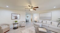 Located at 7901 Heatherbrook Trail in Port Arthur, TX, this single-story, 2-bedroom, 1-bathroom home offers a practical and comfortable layout across its well-utilized floor plan. The open-concept kitchen and living area serves as the heart of the home, with the kitchen featuring white shaker cabinetry, gray countertops, light wood-look flooring, and a full suite of black appliances including a refrigerator, electric range, over-the-range microwave, and dishwasher. The adjoining living room is bright and airy, with a ceiling fan, recessed lighting, and a window that invites natural light. Both bedrooms are carpeted and include ceiling fans and windows, with the primary bedroom offering a generously sized closet. A dedicated utility room houses in-unit washer connections, adding everyday convenience. The full bathroom includes a tub/shower combination with built-in shelving and a clean, neutral palette. Throughout the home, white walls and light finishes create a cohesive, move-in-ready atmosphere. A hallway connects the bedrooms and bathroom, contributing to an efficient and functional flow across the entire residence.
