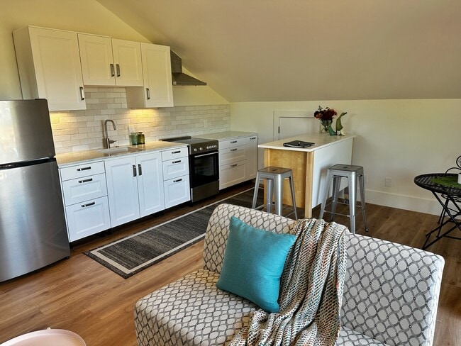 Spacious & bright main room with brand new kitchen and ample room for living room and dining table. - 521 Palm St