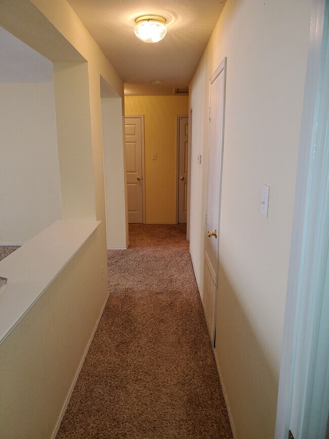 View from Master Bedroom toward bedrooms 1 &amp; 2, Linen Closet and Garage Entry - 3428 Bandera Ranch Rd