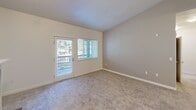 This 2-bedroom, 2-bathroom unit in Lakewood, Washington offers a thoughtfully designed single-level layout. The living room serves as the centerpiece of the home, featuring vaulted ceilings, soft carpeting, and a tile-surround fireplace with a built-in arched niche above the mantle. A glass-paned door opens directly to a balcony, allowing natural light and outdoor views to fill the space.

The kitchen is efficiently arranged with warm wood cabinetry, dark granite countertops, stone tile flooring, and a full suite of stainless steel appliances including a refrigerator, range, and microwave. A peninsula counter provides a functional pass-through to the living area.

Both bedrooms are carpeted and naturally lit by windows with outdoor views. The primary bedroom includes balcony access via a glass door, while the secondary bedroom features a dedicated window and neutral-toned walls. Each bedroom is served by its own full bathroom, both finished with stone tile flooring, wood vanity cabinetry, granite-style countertops, a large mirror, and a tub/shower combination. The layout also includes a hallway and closet for additional storage.