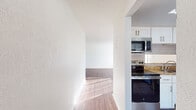 This contemporary apartment offers 1050 square feet of well-designed living space across a single floor. The layout includes three bedrooms, two full bathrooms, a modern kitchen, and a dedicated laundry area. The primary bedroom is generously sized at 190 square feet, providing ample space for comfort and relaxation.

The kitchen is a standout feature, boasting white cabinetry, granite countertops, and stainless steel appliances including a refrigerator, dishwasher, and over-the-range microwave. The subway tile backsplash adds a touch of urban sophistication. 

Both bathrooms are tastefully appointed with white fixtures, granite vanity tops, and a combination of tiled and wood-look flooring. The main bathroom includes a shower/tub combo with white tiled surround.

Throughout the apartment, warm wood-look flooring creates a cohesive and inviting ambiance. The bedrooms are bright and airy, with ample closet space and ceiling fans for comfort. Large windows in the bedrooms allow for natural light and ventilation.

The in-unit laundry room is equipped with full-sized washer and dryer, complemented by built-in shelving for storage and organization. This thoughtful addition enhances the apartment's convenience and livability.

The open-plan living areas offer flexibility in furniture arrangement and are ideal for both relaxation and entertainment. The neutral color palette throughout provides a blank canvas for personal decor preferences.

Located in the Summit West complex, unit 35F-C2 combines modern amenities with practical design, creating an ideal urban living space.