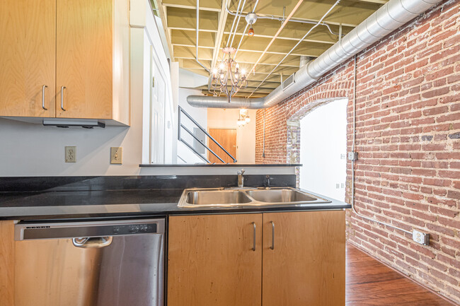 View from kitchen with original industrial brick wall - 158 Walker St SW