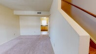 Located at 503 Winston St in Richmond, Virginia, this two-floor home offers a practical and comfortable layout with a mix of flooring styles and functional living spaces throughout. The entry level welcomes visitors through a paneled front door into a foyer with tile flooring that transitions into plush carpeting across the main living area. The open living space is bright and airy, with a staircase leading to the upper floor and a direct sightline into the kitchen. The kitchen is well-equipped with light wood cabinetry, dark countertops, a gas range, a full-size refrigerator, and a single-basin sink beneath a window that allows natural light to fill the space. Tile flooring completes the kitchen's clean, practical aesthetic. Upstairs, the home features warm hardwood flooring throughout the bedrooms, lending a classic and inviting character to the upper level. The bedrooms are generously sized with neutral walls, windows that bring in natural light, and easy access to the shared full bathroom. The bathroom includes a tiled tub-shower combination, toilet, and tile flooring. The overall interior presents a clean, move-in ready environment with a straightforward layout suited for everyday living.