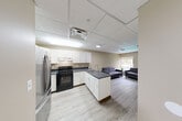Located at 536 S University Ave in Ann Arbor, MI, this single-floor, 3-bedroom, 2-bathroom unit offers a functional and modern layout designed for comfortable living. The open-concept great room seamlessly connects the kitchen, dining, and living areas, creating a spacious and social atmosphere. The kitchen is well-appointed with crisp white shaker cabinets, dark granite countertops, a double-basin stainless steel sink, a black electric range, and a stainless steel French door refrigerator. A peninsula extends the counter space and defines the transition into the dining and living areas. The living room features light wood-look flooring, a drop ceiling with recessed and flush-mount lighting, and a window that brings in natural light. Each of the three bedrooms offers a quiet retreat with closet storage and light wood flooring, while the primary bedroom includes a large window with outdoor views. The two bathrooms are finished with granite-top vanities featuring rich wood cabinetry and a full tub-shower combination. Additional hallway space and a dedicated utility room add to the overall practicality of this well-organized unit.