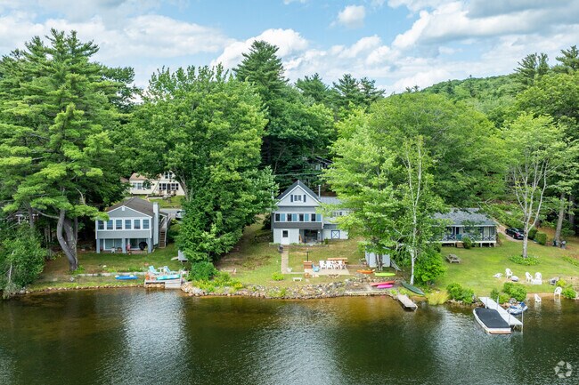 Many colonial and raised-ranch homes with private water access line Lake Winnipesaukee.