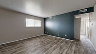 Located at 2029 N Woodlawn St in Wichita, Kansas, this single-floor, 3-bedroom, 1-bathroom home offers a practical and well-appointed layout. The living area welcomes you through a bold teal entry door and features wood-look plank flooring that extends throughout the main living spaces, complemented by a ceiling fan overhead. The open flow between the living room and kitchen creates a connected, functional feel.

The kitchen is outfitted with warm oak cabinetry, granite-style countertops, a stainless steel sink, and white appliances, providing ample storage and prep space. A textured ceiling adds classic character throughout the home.

The spacious primary bedroom is a standout feature, offering generous square footage, dual windows that bring in natural light, soft carpeting, and access to a dedicated walk-in closet complete with dual hanging rods and wood-look flooring. The additional bedrooms include one with a striking teal accent wall and wood-look flooring, adding a modern design touch.

The full bathroom features oak vanity cabinetry, granite-style countertops, a vessel sink with a contemporary faucet, a tub-shower combination, and matching wood-look flooring. A connecting hallway ties the layout together efficiently, making this home both comfortable and easy to navigate.