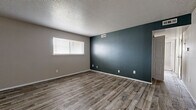 Located at 2029 N Woodlawn St in Wichita, Kansas, this single-floor, 3-bedroom, 1-bathroom home offers a practical and well-appointed layout. The living area welcomes you through a bold teal entry door and features wood-look plank flooring that extends throughout the main living spaces, complemented by a ceiling fan overhead. The open flow between the living room and kitchen creates a connected, functional feel.

The kitchen is outfitted with warm oak cabinetry, granite-style countertops, a stainless steel sink, and white appliances, providing ample storage and prep space. A textured ceiling adds classic character throughout the home.

The spacious primary bedroom is a standout feature, offering generous square footage, dual windows that bring in natural light, soft carpeting, and access to a dedicated walk-in closet complete with dual hanging rods and wood-look flooring. The additional bedrooms include one with a striking teal accent wall and wood-look flooring, adding a modern design touch.

The full bathroom features oak vanity cabinetry, granite-style countertops, a vessel sink with a contemporary faucet, a tub-shower combination, and matching wood-look flooring. A connecting hallway ties the layout together efficiently, making this home both comfortable and easy to navigate.