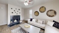 Located in Taylorsville, Utah, this single-floor, 2-bedroom, 2-bathroom home offers a thoughtfully designed layout with a clean, modern aesthetic. The living room serves as the heart of the space, featuring wood-style flooring, a ceiling fan, a tiled fireplace, and sliding glass doors that open to a private patio, allowing ample natural light to fill the room. The combined dining room and kitchen is efficiently designed with a galley-style layout, offering white shaker cabinetry, gray countertops, a double basin sink, and black appliances, including a refrigerator and range. Both bathrooms feature white vanity cabinetry, gray countertops, large mirrors, and shower-tub combinations with clean, neutral finishes. The spacious primary bedroom features plush carpeting and a calm, neutral palette. The second bedroom is equally well-sized, also with carpet flooring and a large window that brings in natural light. Additional conveniences include two closets, an in-unit laundry area, and a hallway connecting the main spaces. The overall ambiance is bright and contemporary, with consistent neutral tones and modern finishes carried throughout the entire home.