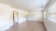 Located at 1000 Old Brook Road in Charlottesville, Virginia, this two-story residence offers four bedrooms and three bathrooms distributed evenly across two floors. The layout is thoughtfully organized, with living areas, a kitchen, and staircase connections providing smooth flow between levels.

The living rooms feature light-toned hardwood-style flooring, crisp white walls, and elegant crown molding that adds a classic architectural touch. Natural light filters through the windows, contributing to a bright and airy atmosphere throughout the common areas.

The kitchen is equipped with stainless steel appliances, including a range, over-the-range microwave, and dishwasher. Warm wood-toned cabinetry pairs with dark countertops, and a window above the sink brings in additional natural light.

The bedrooms are finished with plush carpeting, white walls, and crown molding, creating comfortable and inviting retreats. The primary bedroom offers a generous footprint with ample space for furnishings. The three bathrooms feature wood-toned vanities with white countertops, mirrors, and clean, neutral finishes throughout.

Additional spaces include a hallway, a closet for storage, and two staircases connecting the floors. The overall ambiance is clean, neutral, and move-in ready, making this Charlottesville residence a functional and well-appointed home.