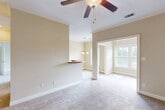 Located at 3150 Skinner Mill Rd in Augusta, Georgia, this single-floor, one-bedroom, one-bathroom home offers a comfortable and functional layout across a well-utilized floor plan. Warm neutral tones, plush carpeting, and crown molding throughout lend a cohesive, inviting ambiance to the living spaces.

The living room features a ceiling fan and opens toward a half-wall breakfast bar that connects to the galley-style kitchen. The kitchen is outfitted with rich dark wood cabinetry, granite-look countertops, a double basin sink, tile flooring, and stainless steel appliances including a refrigerator, electric range, microwave, and dishwasher. An adjoining dining area is highlighted by an elegant multi-globe chandelier and abundant natural light.

The spacious bedroom is carpeted, includes a ceiling fan, and is bathed in natural light through large windows with blinds. Multiple closets provide ample storage. A bonus room off the bedroom offers additional flexible living space, also featuring large windows with views of surrounding greenery.

The bathroom includes a full tub-shower combination, tile flooring, a vanity with granite-look countertop, and dark wood cabinetry. The dedicated laundry room features tile floors, upper cabinetry for storage, and washer/dryer hookups. A hallway connects the various spaces, completing this well-appointed home.