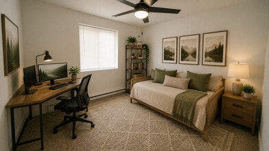 Furnished Bedrooms with desk and ceiling fan - Southgate Gardens Apartments