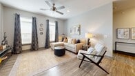 Located in Murfreesboro, Tennessee, this thoughtfully designed 2-bedroom, 2-bathroom residence offers a comfortable and modern living experience across a single floor. The open-concept kitchen flows seamlessly into the living area, featuring white shaker cabinetry, granite countertops, a subway tile backsplash, stainless steel appliances, and a center island with bar seating and pendant lighting — ideal for both cooking and entertaining. Wood-style plank flooring runs throughout the main living areas, complemented by neutral tones that create a bright, welcoming atmosphere. The spacious living room benefits from multiple windows that invite natural light and is finished with a ceiling fan overhead. The generously sized primary bedroom offers plush carpet, a ceiling fan, and ample natural light, while its walk-in closet features built-in wire shelving for organized storage. Both bathrooms are finished with marble-style tile flooring, white vanities with granite countertops, and tiled shower surrounds — one with a soaking tub and one with a glass-enclosed walk-in shower. A stacked in-unit washer and dryer adds everyday convenience. The residence also includes a private balcony, providing an outdoor retreat.