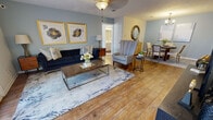This single-story, 3-bedroom, 2-bathroom home in Brandon, Mississippi offers a thoughtfully designed layout that balances comfort and functionality. Warm hardwood flooring flows throughout the main living areas, connecting the living room, dining room, and kitchen in a cohesive, open arrangement.

The living room is bright and inviting, featuring a ceiling fan, soft blue-gray walls, and large patio doors that admit generous natural light. It opens seamlessly into the dining area, which is accented by a chandelier overhead and ample wall space. The kitchen is well-equipped with dark wood cabinetry, stone-look countertops, a subway tile backsplash, and stainless steel appliances including a gas range and built-in microwave.

The spacious primary bedroom features plush carpeting, a ceiling fan, and a window with outdoor views, while its en-suite bathroom includes a tub-shower combo and a vanity with quartz-style countertops. The additional bedrooms are carpeted and comfortably sized. A centrally located hallway connects the bedrooms to the shared bathroom, which also features updated cabinetry and overhead storage.

A dedicated laundry room with side-by-side washer and dryer hookups adds everyday convenience. The home's neutral palette and modern finishes throughout create a clean, welcoming atmosphere.