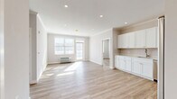 Located at 495 E Main St in Denville, NJ, this thoughtfully designed 2-bedroom, 2-bathroom residence offers a bright and contemporary living experience. The open-concept layout seamlessly connects the living room, dining area, and kitchen, all finished with light-toned luxury vinyl plank flooring and crisp white walls that maximize the natural light flowing through large windows and a balcony door. Recessed lighting throughout adds a clean, modern touch.

The kitchen is a standout feature, outfitted with floor-to-ceiling white shaker cabinetry, light quartz countertops, subway tile backsplash, and a full suite of stainless steel appliances including a refrigerator, range, microwave, and dishwasher. The space opens directly into the dining and living areas, making it ideal for everyday living and entertaining.

Both bedrooms are well-proportioned and sun-filled, with the generously sized primary bedroom offering ample space and natural light. Four closets throughout the residence provide excellent storage. The two bathrooms are finished with large-format tile flooring, white vanities with stone countertops, and subway tile shower surrounds with brushed nickel hardware. A private balcony completes this clean, move-in-ready home.