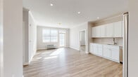 Located at 495 E Main St in Denville, NJ, this thoughtfully designed 2-bedroom, 2-bathroom residence offers a bright and contemporary living experience. The open-concept layout seamlessly connects the living room, dining area, and kitchen, all finished with light-toned luxury vinyl plank flooring and crisp white walls that maximize the natural light flowing through large windows and a balcony door. Recessed lighting throughout adds a clean, modern touch.

The kitchen is a standout feature, outfitted with floor-to-ceiling white shaker cabinetry, light quartz countertops, subway tile backsplash, and a full suite of stainless steel appliances including a refrigerator, range, microwave, and dishwasher. The space opens directly into the dining and living areas, making it ideal for everyday living and entertaining.

Both bedrooms are well-proportioned and sun-filled, with the generously sized primary bedroom offering ample space and natural light. Four closets throughout the residence provide excellent storage. The two bathrooms are finished with large-format tile flooring, white vanities with stone countertops, and subway tile shower surrounds with brushed nickel hardware. A private balcony completes this clean, move-in-ready home.