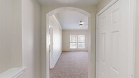 Located at 8035 Ohio Dr in Plano, TX, this single-story, 3-bedroom, 2-bathroom home offers a well-designed layout with thoughtful architectural details throughout. An elegant arched entryway welcomes you into the space, leading to a bright and open living room featuring crown molding, a ceiling fan, plush carpet, and a classic white-mantled fireplace. Natural light flows in through multiple windows fitted with blinds, offering pleasant neighborhood views.

The kitchen is a functional centerpiece, showcasing white shaker cabinetry, granite countertops, a tile backsplash, and a full suite of stainless steel appliances including a refrigerator, gas range, microwave, and dishwasher. A central island provides additional prep and seating space, while wood-style flooring grounds the area with warmth.

The primary bedroom is generously sized, featuring large dual windows and carpeted floors. Two closets offer ample storage, including a walk-in closet with built-in wire shelving. The bathrooms are clean and functional, with one featuring a soaking tub framed by full white tile surround and built-in cabinetry. A dedicated laundry area with an included washer and wire shelving adds everyday convenience. Hallways connect the rooms efficiently throughout the single-level floor plan.