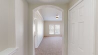 Located at 8035 Ohio Dr in Plano, TX, this single-story, 3-bedroom, 2-bathroom home offers a well-designed layout with thoughtful architectural details throughout. An elegant arched entryway welcomes you into the space, leading to a bright and open living room featuring crown molding, a ceiling fan, plush carpet, and a classic white-mantled fireplace. Natural light flows in through multiple windows fitted with blinds, offering pleasant neighborhood views.

The kitchen is a functional centerpiece, showcasing white shaker cabinetry, granite countertops, a tile backsplash, and a full suite of stainless steel appliances including a refrigerator, gas range, microwave, and dishwasher. A central island provides additional prep and seating space, while wood-style flooring grounds the area with warmth.

The primary bedroom is generously sized, featuring large dual windows and carpeted floors. Two closets offer ample storage, including a walk-in closet with built-in wire shelving. The bathrooms are clean and functional, with one featuring a soaking tub framed by full white tile surround and built-in cabinetry. A dedicated laundry area with an included washer and wire shelving adds everyday convenience. Hallways connect the rooms efficiently throughout the single-level floor plan.