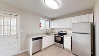 Located on Old Forest Road in Lynchburg, Virginia, this single-floor unit offers three bedrooms, one bathroom, and a kitchen within a compact yet efficiently utilized footprint. The interior presents a clean, updated aesthetic characterized by neutral warm-gray walls, light wood-style luxury vinyl plank flooring in the main living areas, and carpeted bedrooms.

The kitchen is a standout feature, outfitted with white shaker-style cabinetry, light granite-look countertops, a white subway tile backsplash, and stainless steel appliances including a dishwasher, electric range, and refrigerator. A window above the sink provides natural light.

The primary bedroom is notably spacious relative to the overall floor plan, featuring large windows with horizontal blinds that allow ample natural light and views of the surrounding area. The two additional bedrooms are carpeted and similarly bright, each with windows and closets.

The shared bathroom includes a white vanity with cabinet storage, a wall mirror, and a bathtub, finished with light wood-style flooring. The entry area opens directly into the living space, which features a large window and light-filled interior. Overall, the unit presents a well-maintained, move-in-ready environment.
