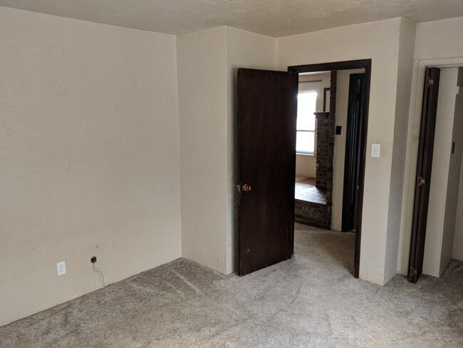 Bedroom 2. We are replacing the carpet with premium LVP. - 5235 Highway NN