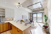 Located at 1621 Lauzon Rd in Windsor, Ontario, this contemporary 2-bedroom, 2-bathroom unit offers a thoughtfully designed open-concept layout across a single floor. The combined kitchen and living area serves as the heart of the home, featuring stainless steel appliances, warm wood cabinetry, a decorative patterned tile backsplash, and a generous quartz-topped island ideal for dining or entertaining. Track lighting and a sculptural pendant fixture illuminate the space, while exposed concrete accents and visible ductwork lend an industrial-chic character. The living area is anchored by large sliding glass doors that flood the room with natural light and open directly onto a private balcony, offering expansive views of the Windsor skyline and surrounding landscape. The primary bedroom continues the modern aesthetic with a full-height sliding door to the balcony, exposed concrete walls, and light hardwood flooring. The second bedroom is equally well-appointed with its own access to outdoor views. Both bathrooms are finished with sleek floating vanities, large-format tile flooring, and modern fixtures. A dedicated laundry room houses stacked Electrolux washer and dryer units alongside a utility sink, adding everyday practicality. A closet completes the layout of this well-appointed urban residence.