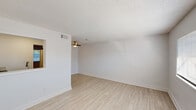 This single-floor, one-bedroom, one-bathroom unit in Milton, Florida offers a clean, modern living experience with a thoughtfully updated interior. Light wood-look flooring flows consistently throughout the space, complementing the crisp white walls and creating a bright, cohesive aesthetic.

The open living area is bathed in natural light from a wide front-facing window fitted with horizontal blinds. A ceiling fan overhead provides added comfort, while a pass-through window connects the living area to the kitchen, enhancing the sense of openness. Textured ceilings add a classic touch throughout.

The kitchen is well-appointed with white shaker-style cabinetry, granite-look countertops, a subway tile backsplash, and stainless steel appliances including a full-size refrigerator and electric range with an overhead exhaust hood. Light wood flooring continues seamlessly into this compact yet functional cooking space.

The bedroom is generously sized with a large window that fills the room with natural light. A louvered closet door provides convenient storage, and the neutral tones keep the room feeling calm and airy.

The bathroom features a full tub-shower combination with white tile surround, a vanity with light countertops, wood-look flooring, and a bright window that keeps the space feeling fresh and open. This unit offers a clean, move-in-ready living environment.