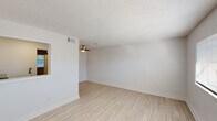 This single-floor, one-bedroom, one-bathroom unit in Milton, Florida offers a clean, modern living experience with a thoughtfully updated interior. Light wood-look flooring flows consistently throughout the space, complementing the crisp white walls and creating a bright, cohesive aesthetic.

The open living area is bathed in natural light from a wide front-facing window fitted with horizontal blinds. A ceiling fan overhead provides added comfort, while a pass-through window connects the living area to the kitchen, enhancing the sense of openness. Textured ceilings add a classic touch throughout.

The kitchen is well-appointed with white shaker-style cabinetry, granite-look countertops, a subway tile backsplash, and stainless steel appliances including a full-size refrigerator and electric range with an overhead exhaust hood. Light wood flooring continues seamlessly into this compact yet functional cooking space.

The bedroom is generously sized with a large window that fills the room with natural light. A louvered closet door provides convenient storage, and the neutral tones keep the room feeling calm and airy.

The bathroom features a full tub-shower combination with white tile surround, a vanity with light countertops, wood-look flooring, and a bright window that keeps the space feeling fresh and open. This unit offers a clean, move-in-ready living environment.