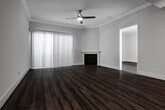 Located at 527 Midvale Ave in the desirable Westwood neighborhood of Los Angeles, this single-floor unit offers a well-designed layout with modern finishes throughout. Rich, dark hardwood-style flooring runs continuously across all living areas, lending warmth and cohesion to the space.

The living room is a standout, featuring crown molding, a classic fireplace, and a ceiling fan. A large sliding glass door floods the room with natural light and opens to a view of lush greenery outside, creating an inviting indoor-outdoor connection.

The kitchen is thoughtfully appointed with dark, contemporary cabinetry, white countertops, a mosaic tile backsplash, stainless steel appliances including a refrigerator and gas range, and a built-in sink — all illuminated by overhead track lighting.

The bedroom offers a generous sliding-door closet with multi-level shelving, providing ample storage. Additional rooms include a secondary space with its own entrance, as well as a bathroom equipped with a full soaking tub and shower combination with chrome fixtures. Recessed lighting and clean white walls throughout contribute to a bright, modern ambiance well-suited for comfortable urban living.