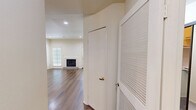 Located at 15130 Dickens St in Sherman Oaks, Los Angeles, this 3-bedroom, 2-bathroom apartment offers a practical and comfortable single-floor layout. The living room serves as the heart of the unit, featuring warm hardwood-style flooring, recessed lighting, and a classic fireplace framed by crisp white millwork. A sliding glass door allows natural light to filter in and provides access to the private outdoor patio, a concrete-floored space enclosed by the building's textured stucco exterior. The kitchen is well-equipped with light wood cabinetry, granite-style countertops, tile flooring, and a full suite of black appliances including a gas range, built-in microwave, dishwasher, and refrigerator. The three bedrooms are carpeted and present a neutral, bright palette with clean walls. The spacious primary bedroom features a sliding glass door with vertical blinds opening to an outdoor view. The two bathrooms are finished with tile flooring and white vanities; one includes a glass-enclosed shower stall with a high window for natural light, while the second offers an elongated vanity. A hallway and closet complete the thoughtfully arranged floor plan.