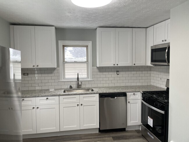 Everything in kitchen is new - soft-close cabinets, granite counters, stainless-steel appliances - 30132 Robert St