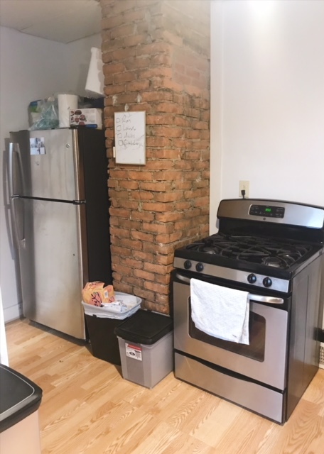 Kitchen Features Exposed Brick, Gas Range, New Fridge - 9702 Baltic Rd