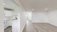 Located at 425 E Willamette Ave in Colorado Springs, Colorado, this two-bedroom, one-bathroom home offers a thoughtfully updated interior designed with a clean, modern aesthetic. The single-floor layout provides an efficient and comfortable flow between living spaces.

The living room is bright and open, featuring light gray luxury vinyl plank flooring and recessed lighting that create a welcoming atmosphere. Large windows allow natural light to fill the space, adding to its airy feel. The kitchen is well-appointed with white shaker-style cabinetry, matte black hardware, light quartz countertops, open shelving, and a matte black faucet — all complemented by matching LVP flooring and white appliances including a refrigerator and range.

Both bedrooms are carpeted for comfort and each include a ceiling fan with light fixture and window with blinds providing natural light and privacy. The primary bedroom offers a generous footprint with ample room for furnishings.

The bathroom features wood-look tile flooring, a white tub-shower combo, matte black fixtures throughout, and crisp white walls for a clean, cohesive look. Two closets provide practical storage throughout the home.

The consistent white walls, modern finishes, and coordinated fixtures across all rooms give this home a fresh, move-in-ready appeal.