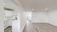 Located at 425 E Willamette Ave in Colorado Springs, Colorado, this two-bedroom, one-bathroom home offers a thoughtfully updated interior designed with a clean, modern aesthetic. The single-floor layout provides an efficient and comfortable flow between living spaces.

The living room is bright and open, featuring light gray luxury vinyl plank flooring and recessed lighting that create a welcoming atmosphere. Large windows allow natural light to fill the space, adding to its airy feel. The kitchen is well-appointed with white shaker-style cabinetry, matte black hardware, light quartz countertops, open shelving, and a matte black faucet — all complemented by matching LVP flooring and white appliances including a refrigerator and range.

Both bedrooms are carpeted for comfort and each include a ceiling fan with light fixture and window with blinds providing natural light and privacy. The primary bedroom offers a generous footprint with ample room for furnishings.

The bathroom features wood-look tile flooring, a white tub-shower combo, matte black fixtures throughout, and crisp white walls for a clean, cohesive look. Two closets provide practical storage throughout the home.

The consistent white walls, modern finishes, and coordinated fixtures across all rooms give this home a fresh, move-in-ready appeal.